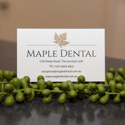 A photography of a Maple Dental business card